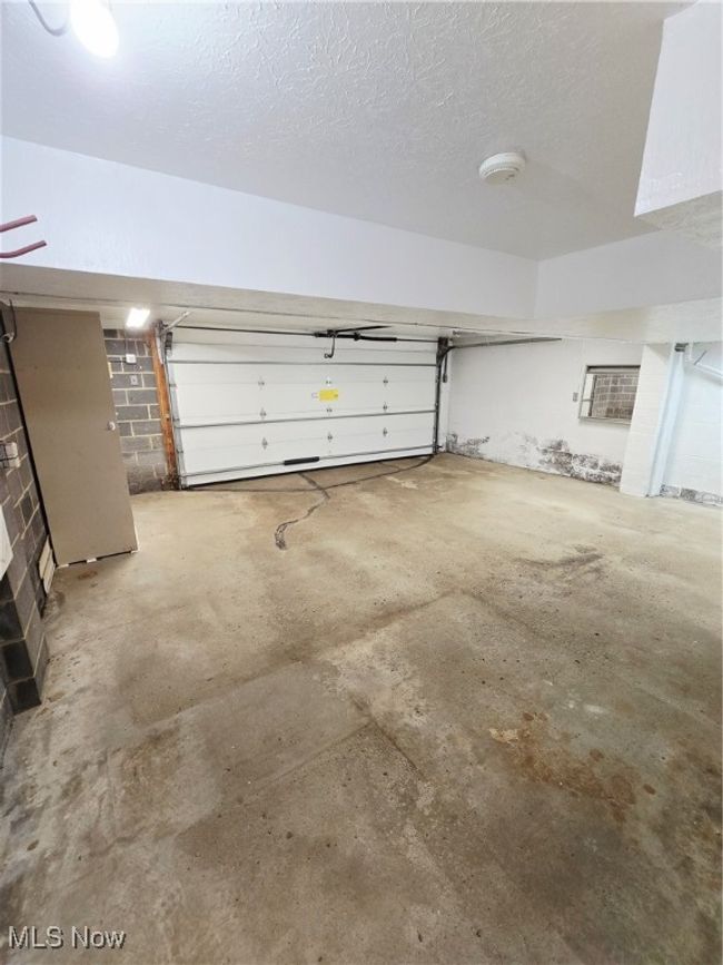Garage featuring concrete block wall | Image 25