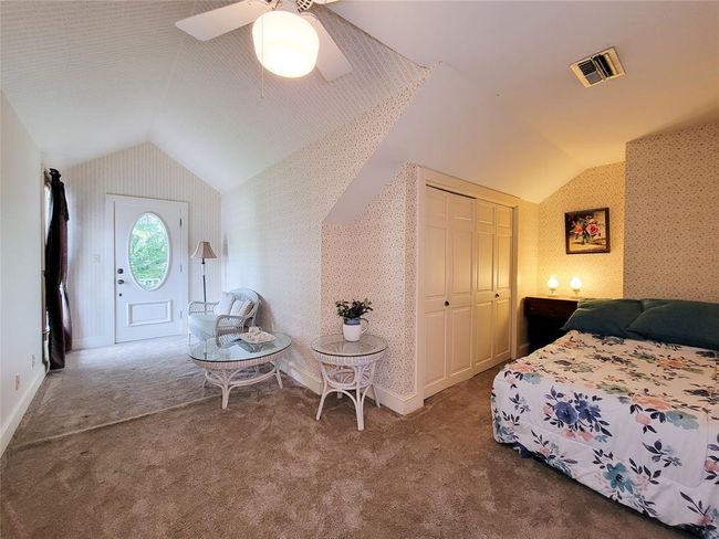 Charming upstairs bedroom with a cozy sitting area, ample closet space, and a private balcony. | Image 28