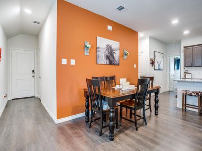 Dining area with light hardwood / wood-style floors and vaulted ceiling | Image 2