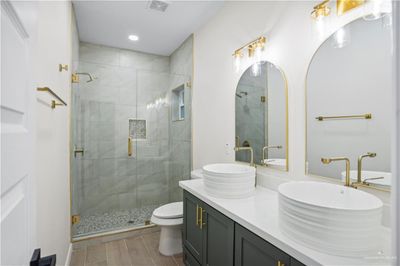 Bathroom with vanity, toilet, and an enclosed shower | Image 3