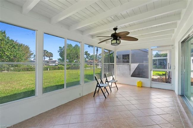 Unfurnished sunroom featuring beam ceiling, wood ceiling, and ceiling fan | Image 17