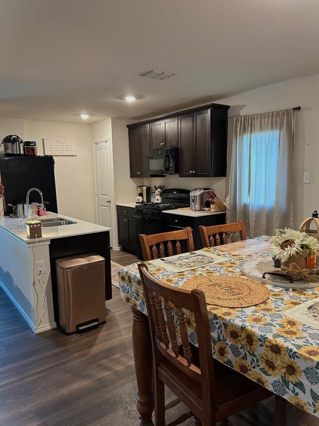 Kitchen features stone countertops, vinyl flooring, double sink, gas range and GE energy star appliances. | Image 8