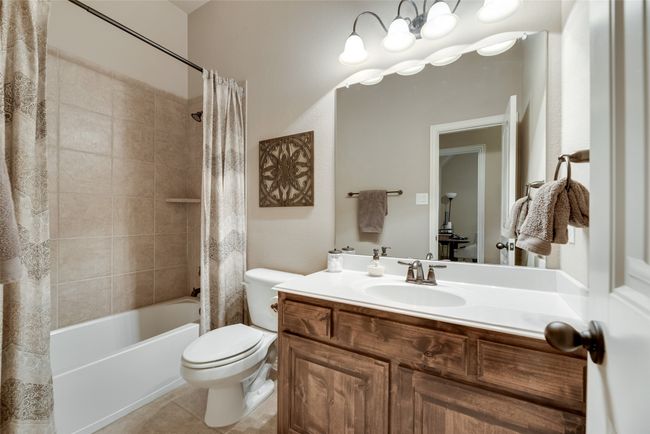 Full bathroom with shower / tub combo with curtain, vanity, and tile patterned flooring | Image 22