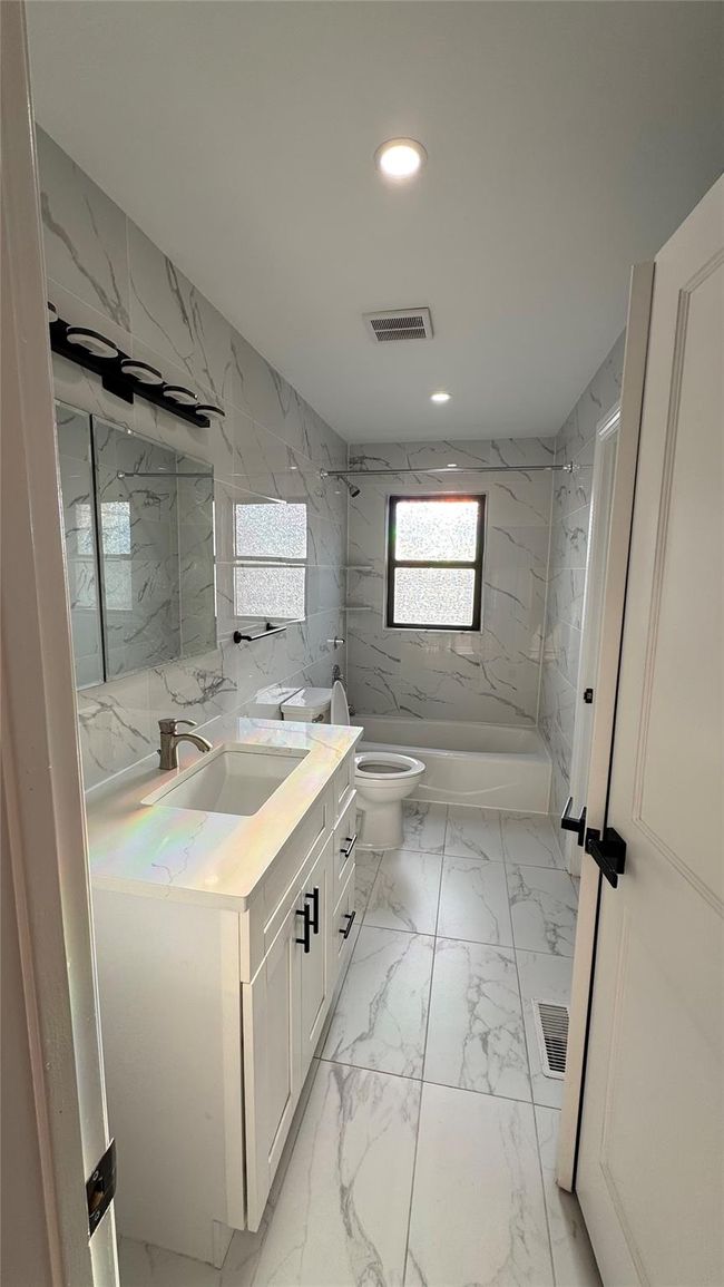 Bathroom featuring vanity, recessed lighting, marble finish flooring, and a combined bath / shower with marble appearance | Image 4