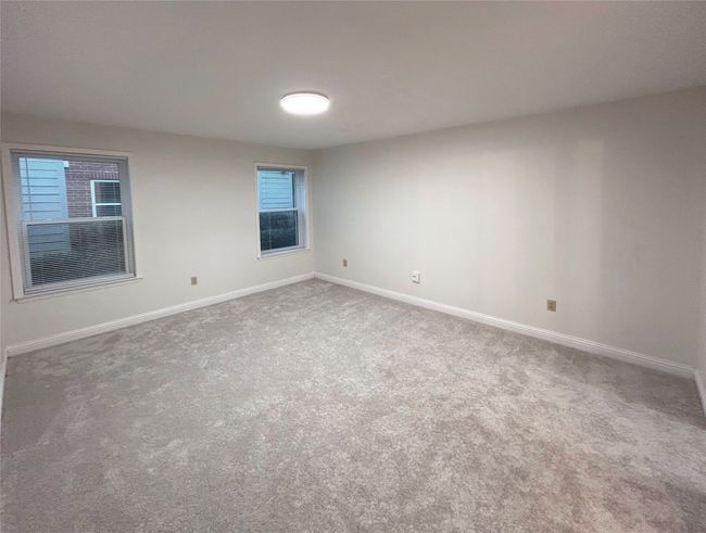 Empty primary bedroom with carpet floors | Image 16