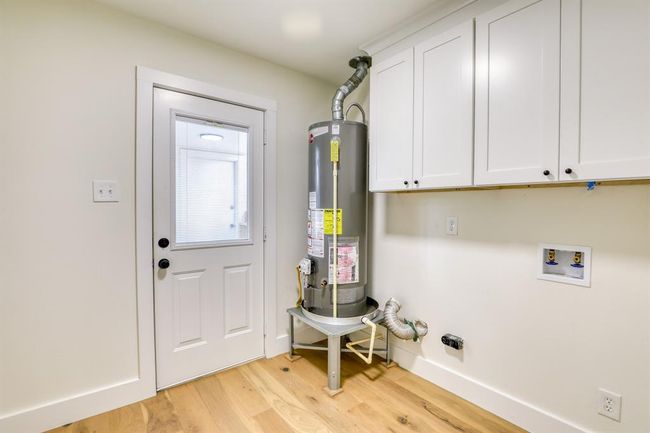 Laundry with new cabinetry and water heater | Image 30
