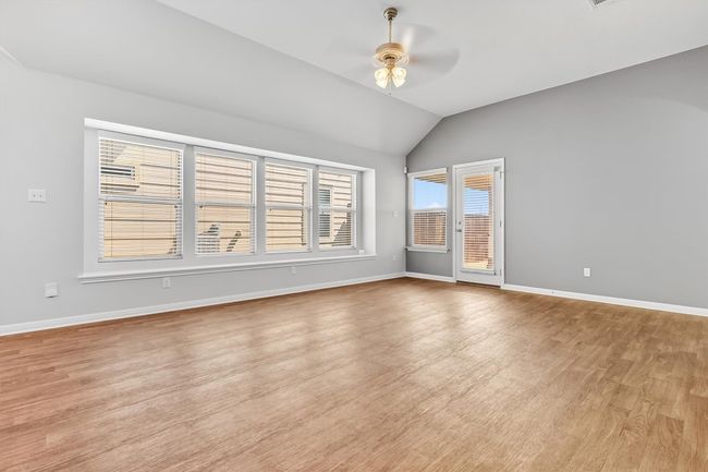 Living room featuring wood finished floors, lofted ceiling, and a ceiling fan | Image 14