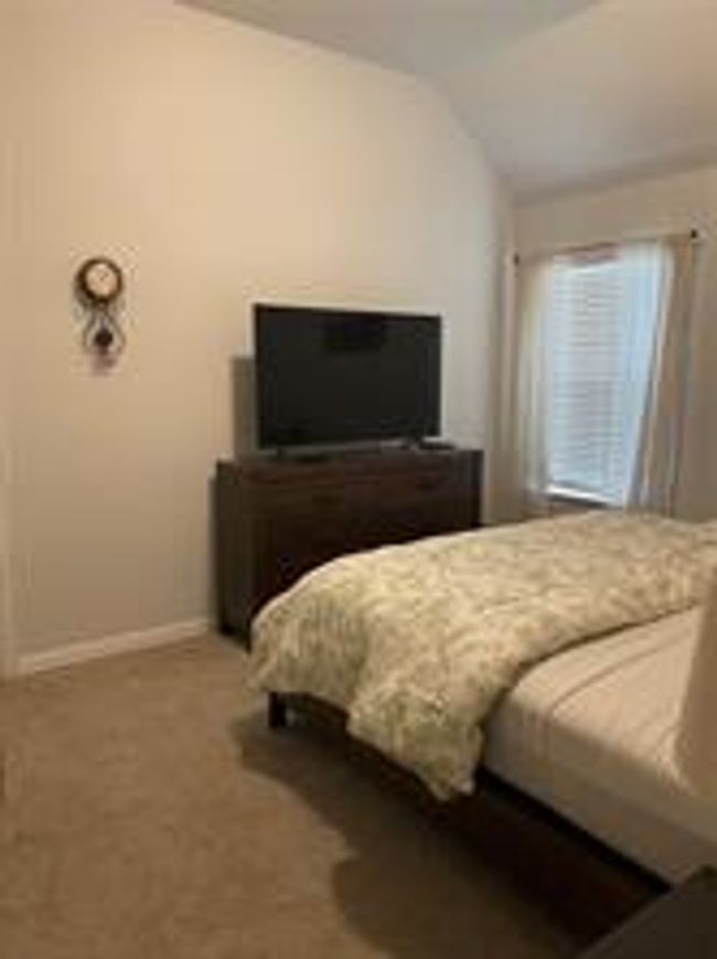 Bedroom with vaulted ceiling and carpet | Image 25