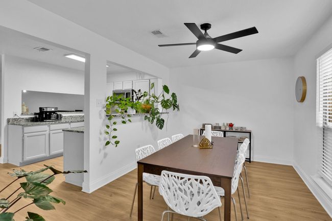 Dining space featuring light wood-type flooring and a ceiling fan | Image 10