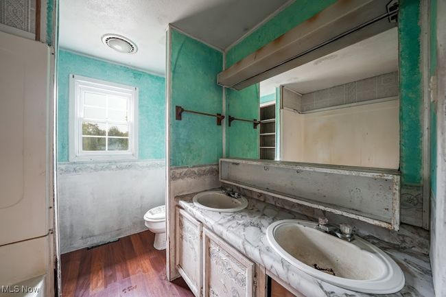 Bathroom with vanity, wood-type flooring, and toilet | Image 7