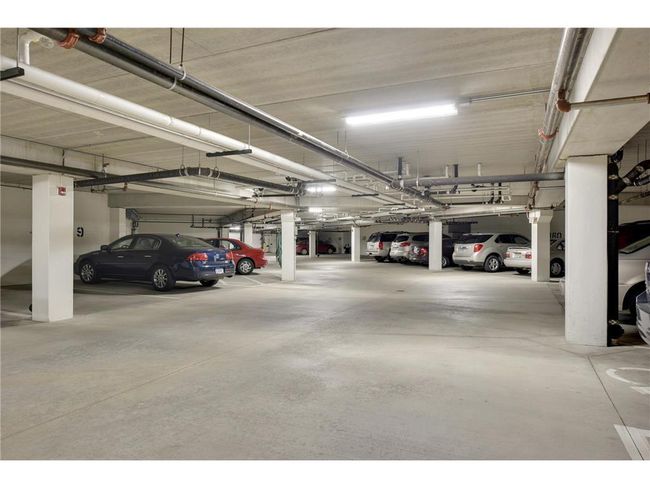 The lower level features a heated, secured garage with deeded parking spaces, cleaned annually, . It also includes a fully equipped workshop, complete with everything needed for creation or restoration projects. | Image 33