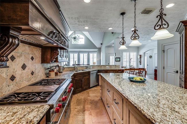 Wonderful Chef's Kitchen with huge fridge Freezer, freezer drawers & 6 gas burner gas cook top, beautiful wooden cabinets and contrasting island and high end granite counters. Fabulous for entertaining Family and friends | Image 16