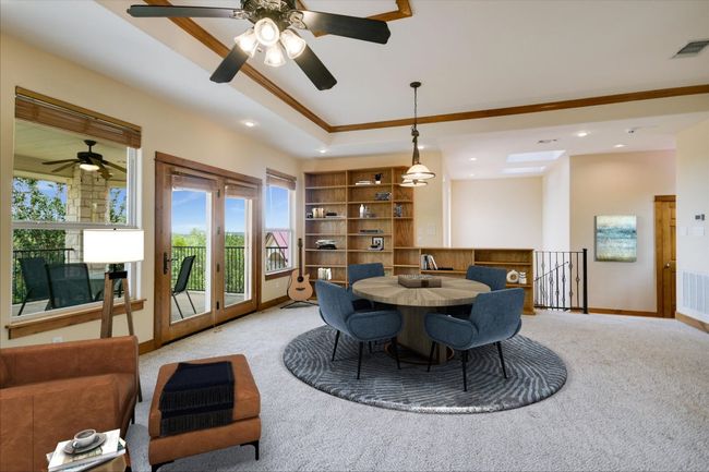 This is the only room upstairs! Natural, spot overhead and pool table specific lighting! This gameroom/library will be a favorite place all day, any day, as beyond the wall of windows is the million dollar view on the patio! There is a 1/2 bath and large storage closet. | Image 12