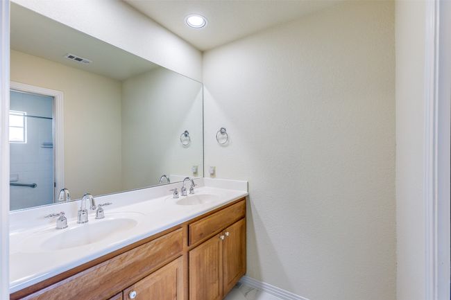 Full bath featuring double vanity and baseboards | Image 23