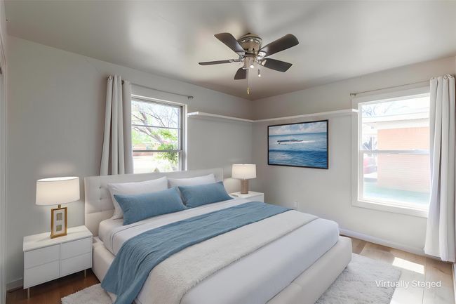 Bedroom with wood finished floors, baseboards, and a ceiling fan | Image 8