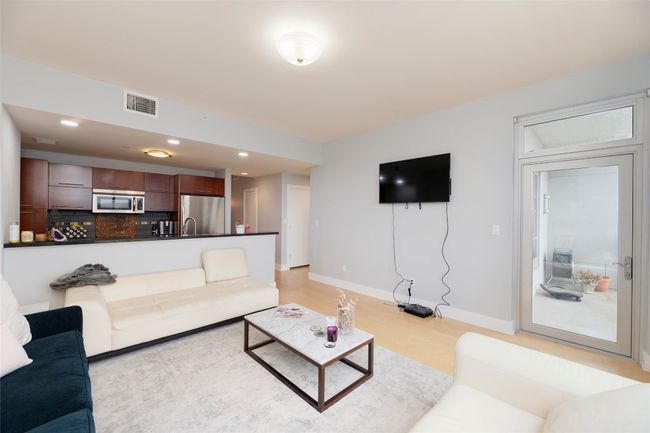 Living room with light wood-type flooring and recessed lighting | Image 7