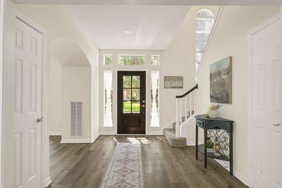 Welcome to the inviting foyer, featuring elegant lighting that created a warm and welcoming atmosphere. | Image 1