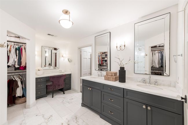 Primary en-suite bathroom includes a large walk in shower, two closets, and a vanity area. | Image 21