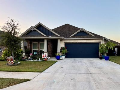 Craftsman-style house with a yard, covered porch, and a garage | Image 1