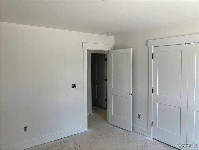 Unfurnished bedroom with baseboards and concrete floors | Image 21