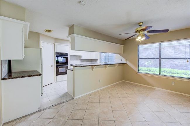 Dining room (right) looking towards the kitchen. | Image 10
