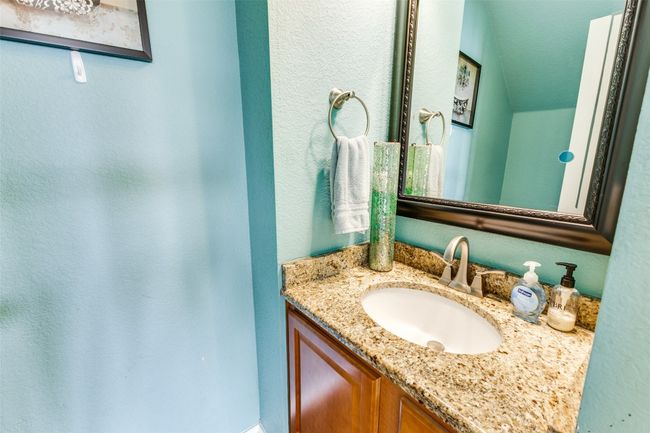 Bathroom with vanity and a textured wall | Image 33