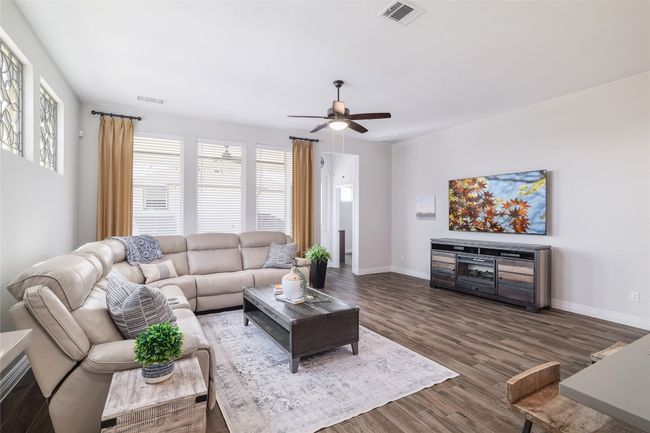 Living area with a ceiling fan and plenty of natural light | Image 13