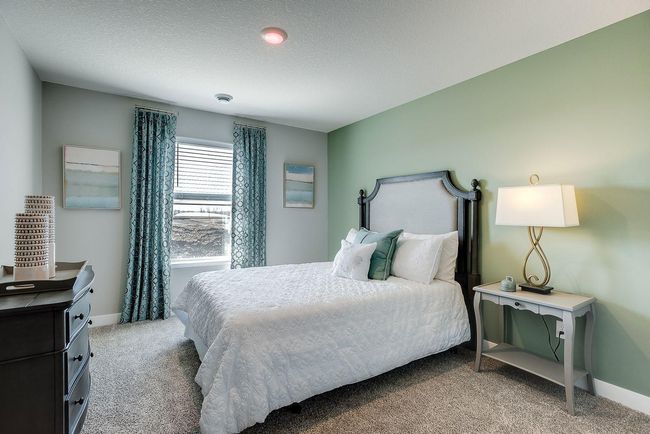 The Finnegan's 4th bedroom found in the completed lower level adject to a full bathroom. Photo of model home, colors and selections shown may vary | Image 16