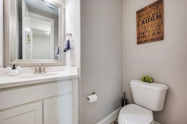 Half bathroom featuring toilet and vanity | Image 30