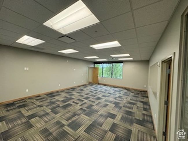 Carpeted empty room with baseboards and a paneled ceiling | Image 22