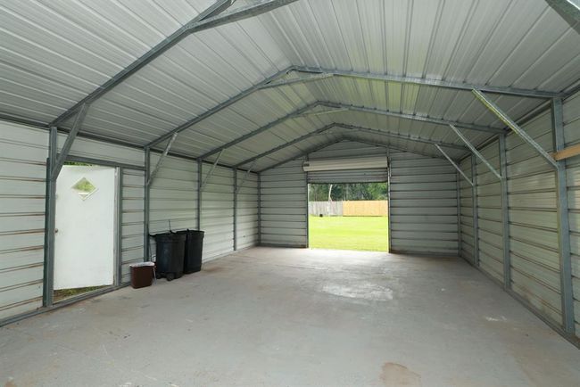 Workshop in backyard One end has a full garage door. | Image 29