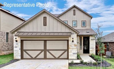 View of front of home featuring central AC unit and a garage | Image 1