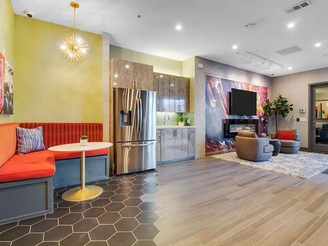 Kitchen with a chandelier, wood finished floors, visible vents, stainless steel refrigerator with ice dispenser, and breakfast area | Image 17