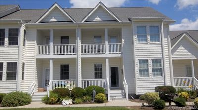 Multi unit property featuring a balcony and a porch | Image 1