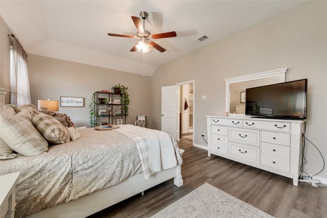 Bedroom with dark wood-type flooring, vaulted ceiling, and ceiling fan | Image 28