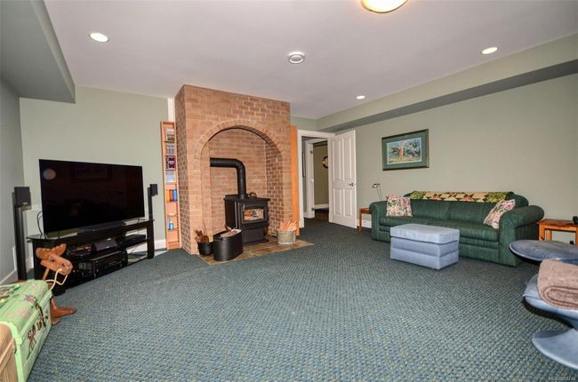 Media / family room with wood stove and recessed lighting | Image 24