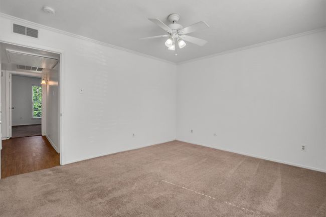 Bedroom featuring a smoke detector, a ceiling fan, crown molding, and attic access | Image 20