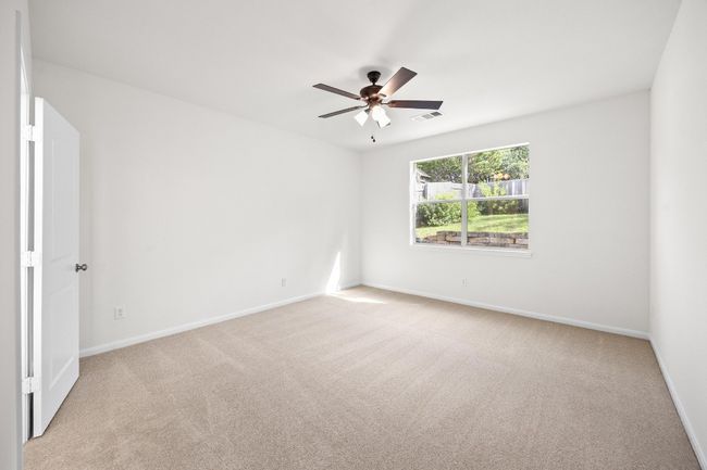 The downstairs master bedrooms has a lot of natural light. | Image 17
