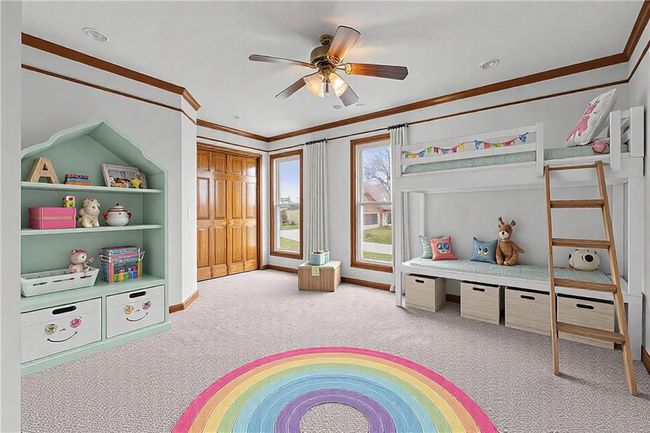 Recreation room with carpet floors, baseboards, ornamental molding, and a ceiling fan | Image 26