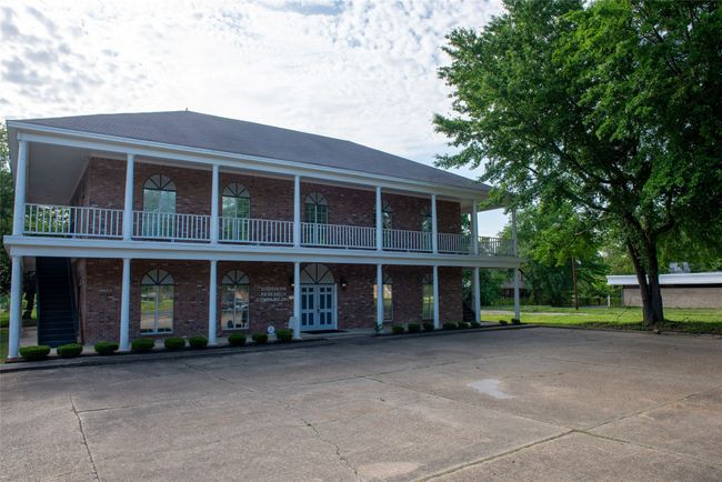 Rear view of house with brick siding and a balcony | Image 24