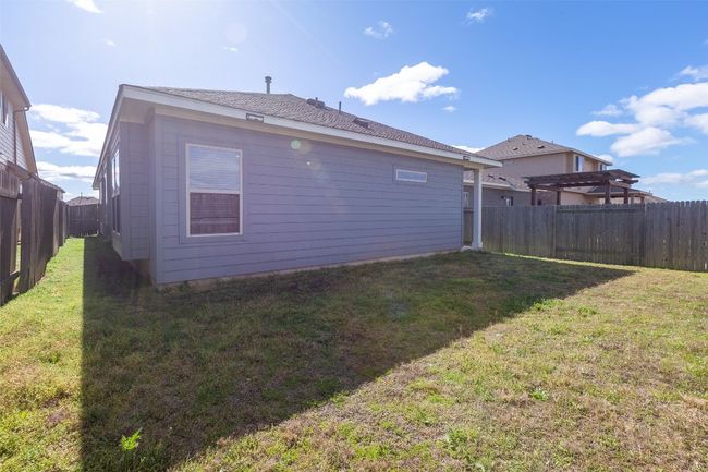 Rear view of house with a lawn and a fenced backyard | Image 34