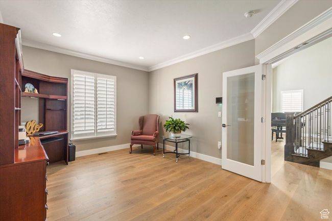Living area featuring french doors, light wood-style floors, ornamental molding, stairs, and baseboards | Image 18