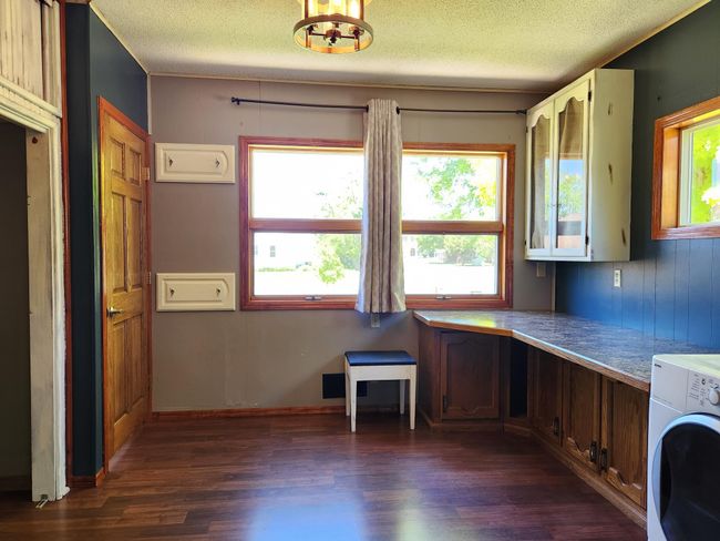 Main floor laundry offers desk/office or project space. | Image 16