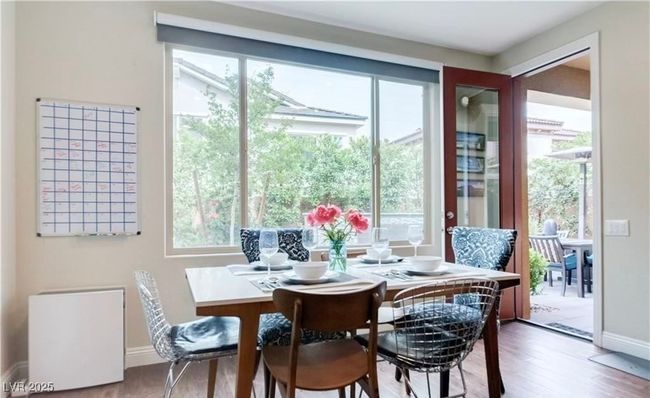 Dining room featuring baseboards and wood finished floors | Image 5