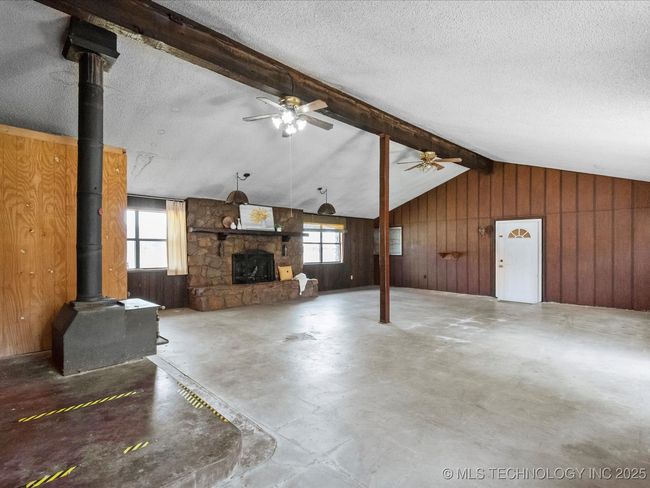 second living area w/ fireplace, back door and garage access | Image 7