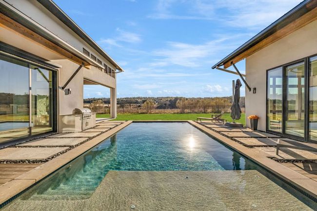 Outdoor pool featuring a grilling area, and patio | Image 30