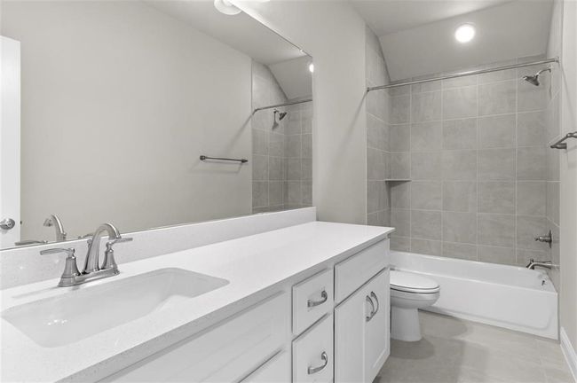 Full bath featuring vanity, toilet, shower / bathtub combination, tile patterned flooring, and recessed lighting | Image 21