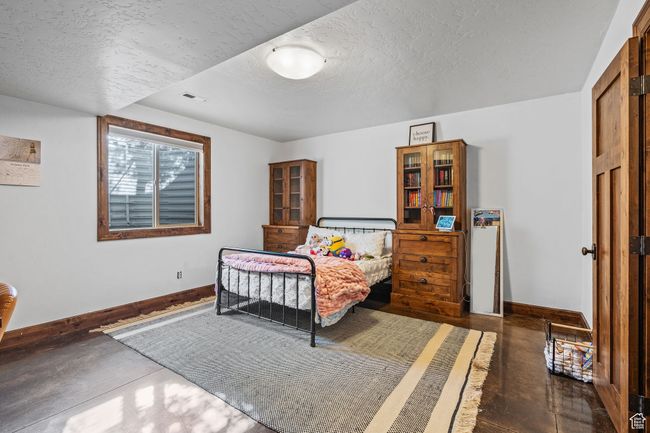 Bedroom with a textured ceiling | Image 43