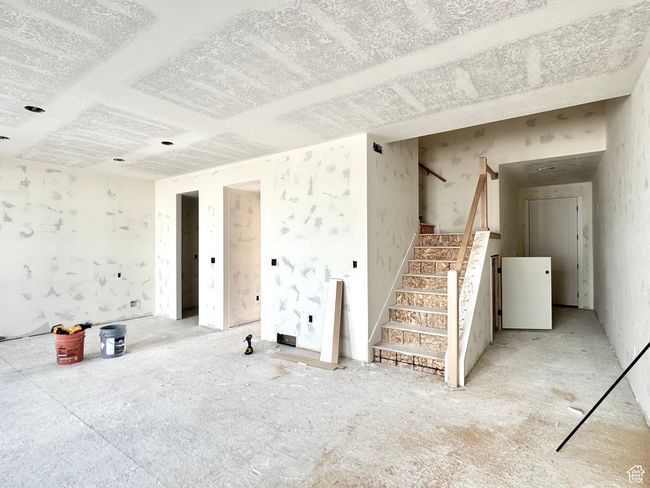 Unfurnished living room with stairs | Image 12
