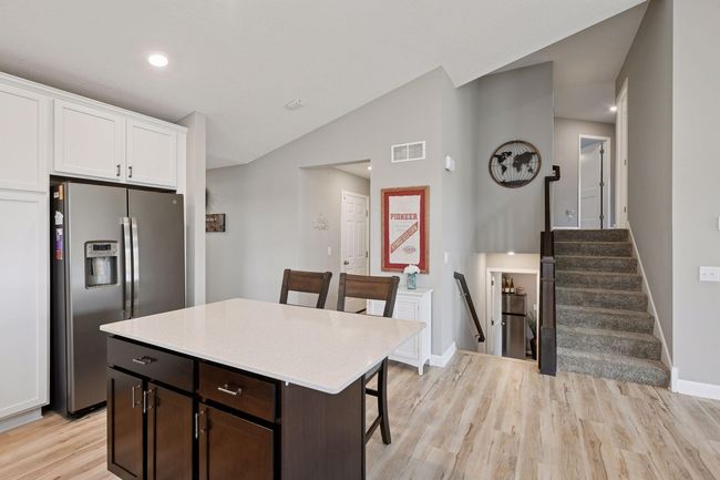 Head upstairs to the bedrooms or downstairs to the family room and walk out basement (and an additional bedroom!) | Image 15